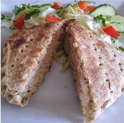 A toasted snack with tuna filling served with salad