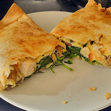 A wrap filled with chicken, spinach and egg