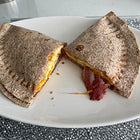 A tortilla with bacon and egg filling