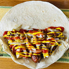 A tortilla filled with meat, mustard and ketchup (2)
