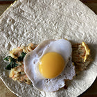 A tortilla with chicken and a fried egg (2)