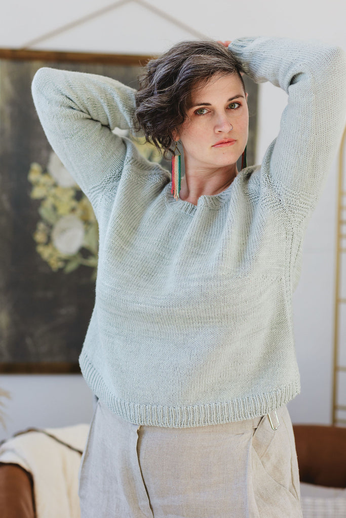 Jen wears a celadon green seamless raglan knit from the top down. This pattern calls for a lofty, grippy yarn.