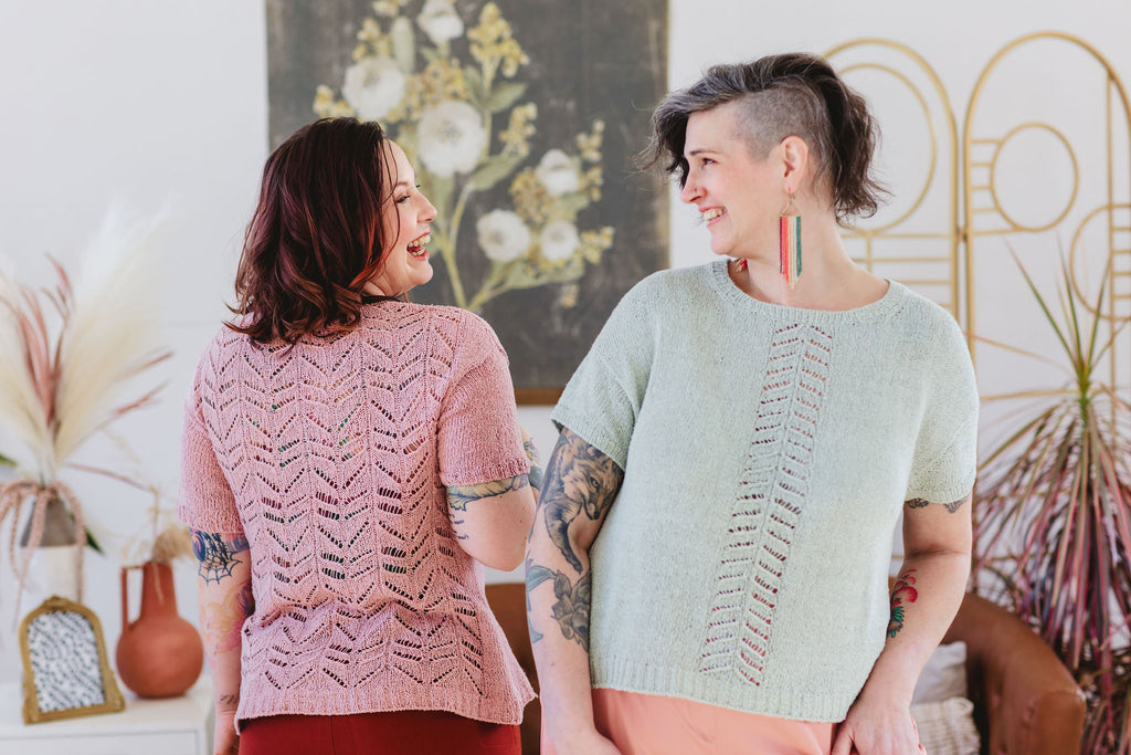 Bess displays the back view of her hand knit lace tee. Jen displays the front view of her Kanno's Resistance knitting pattern tee.