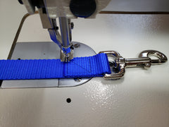 closeup image showing the box stitch used on webbing products in the process of being sewn.