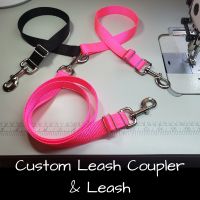 Custom leash coupler with one black side and one neon pink side, with a neon pink hands free leash.