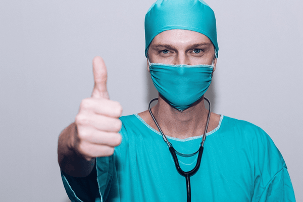 surgeon with a thumbs-up indicating that all is well