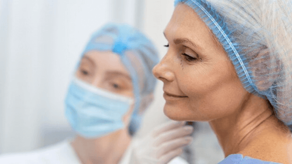 specialist observing the results on the skin of her patient after plastic surgery