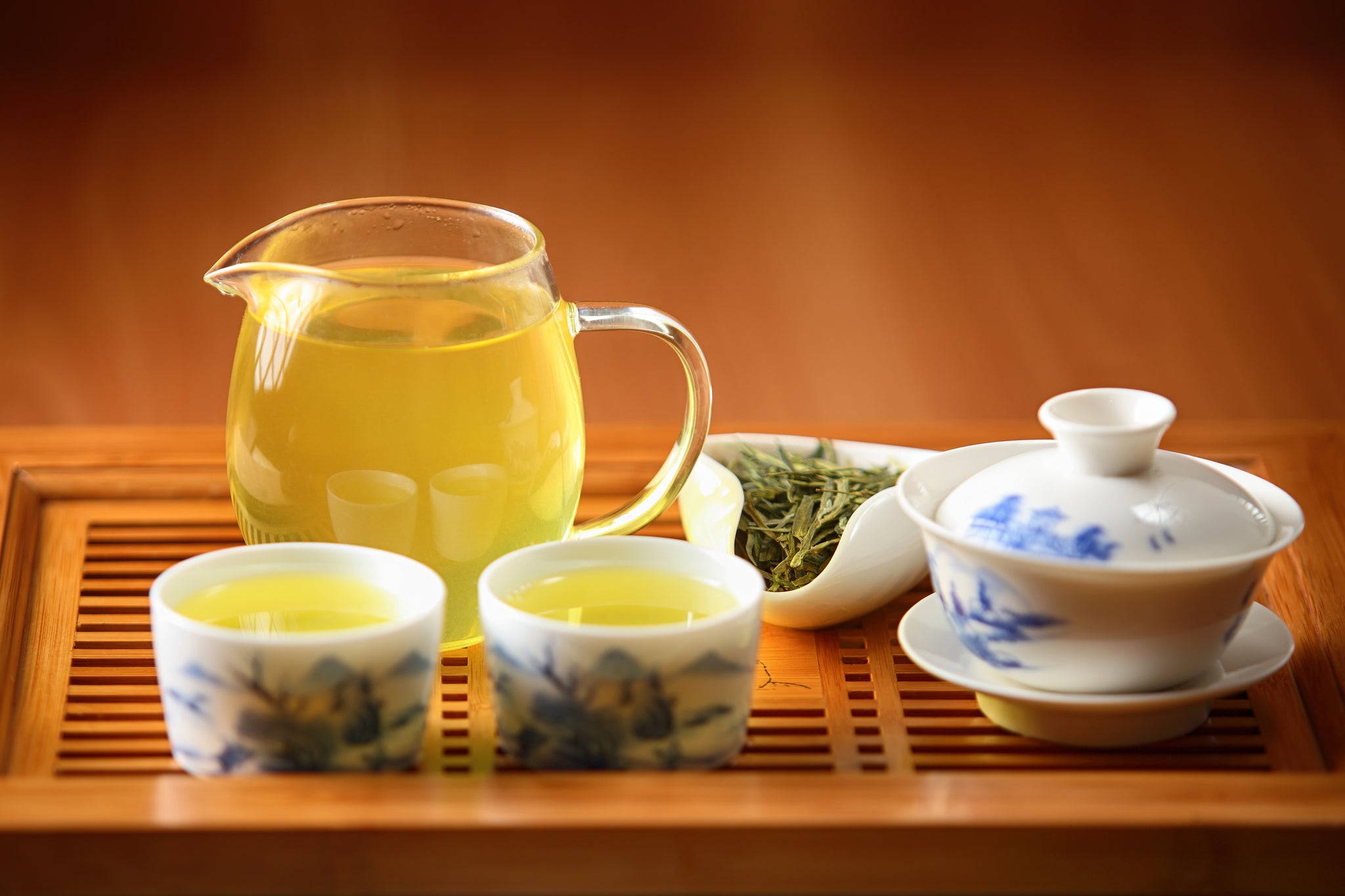 White porcelain gaiwan with green tea on chaban