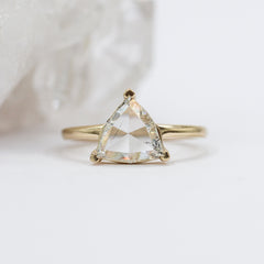 triangle-cut clear diamond in a yellow gold ring