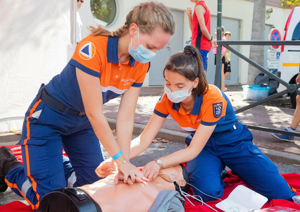 Image of paramedics practising CPR on a mannequin