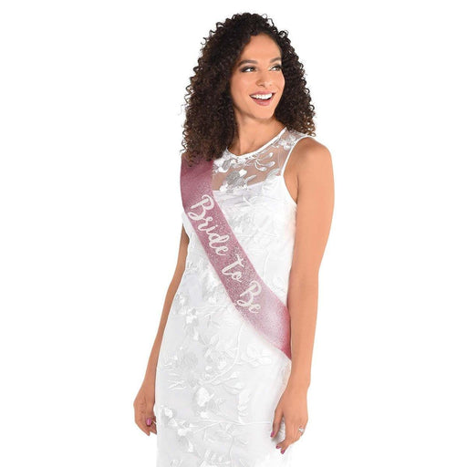 https://cdn.shopify.com/s/files/1/0802/9923/products/amscan-ca-bachelorette-pink-white-bride-to-be-sash-192937029893-13077516648514_512x512.jpg?v=1658513900