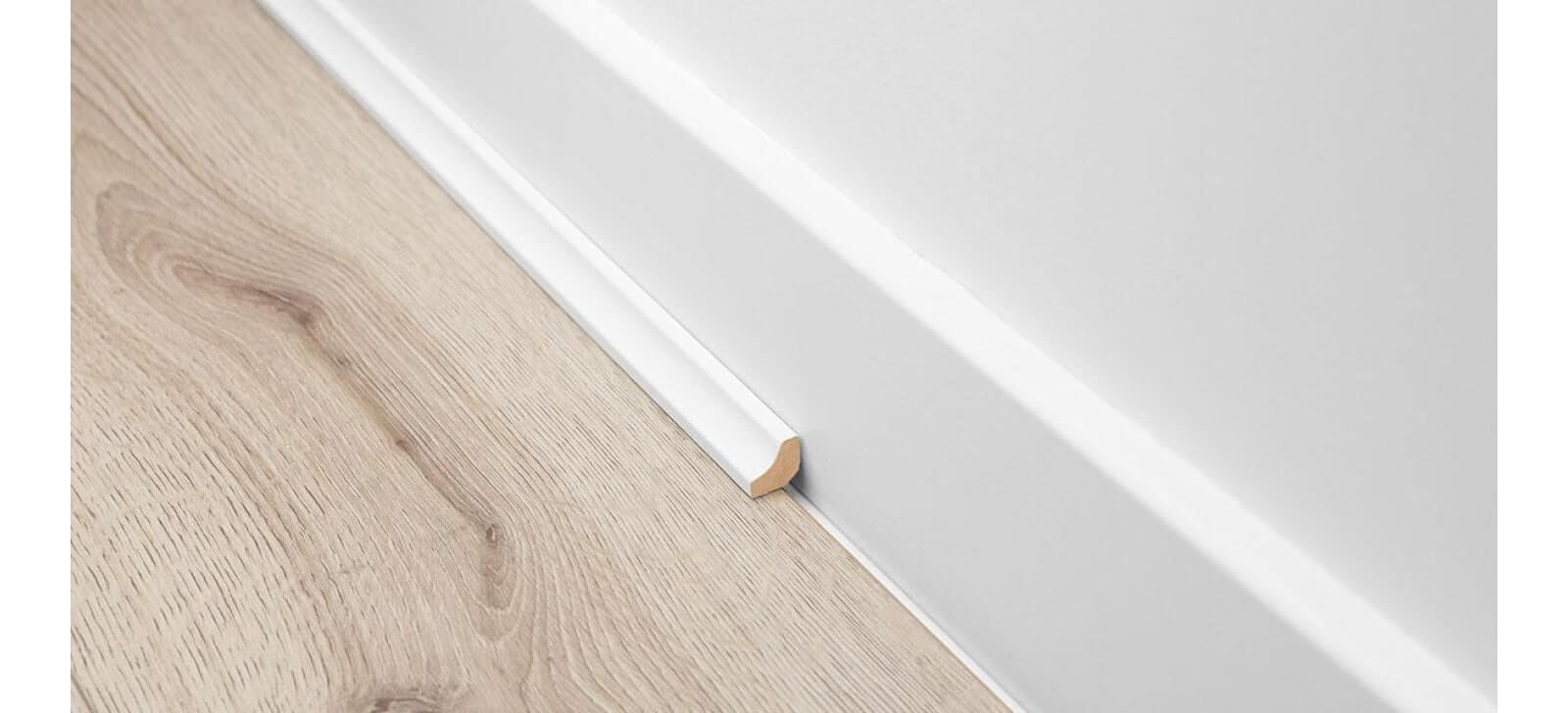 White scotia with wood effect laminate flooring