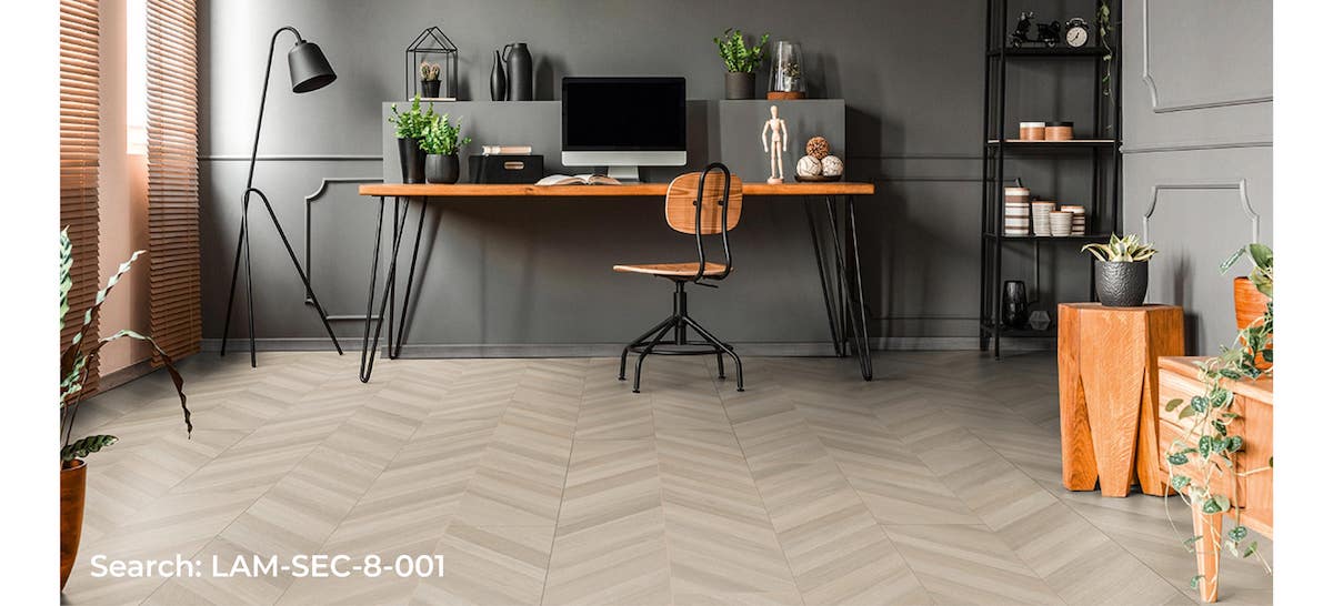 Laminate chevron flooring installed in a home office. The light, natural looking floor helps to brighten up the room