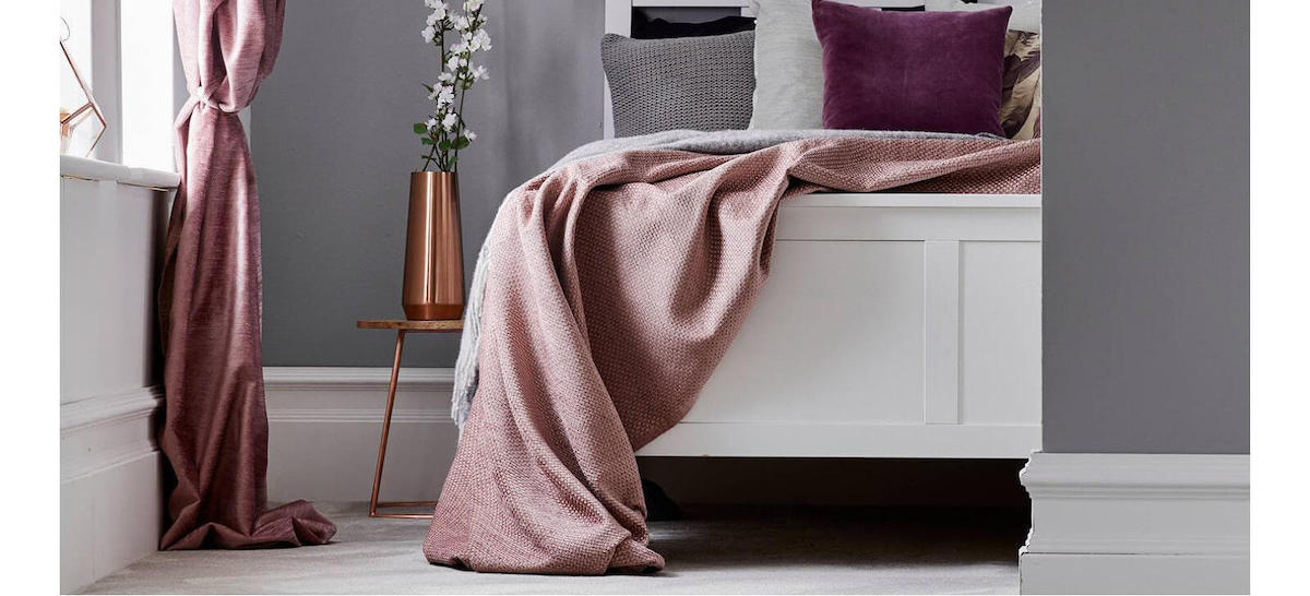 Modern bedroom with grey soft furnishings, dark walls and dark wood floors