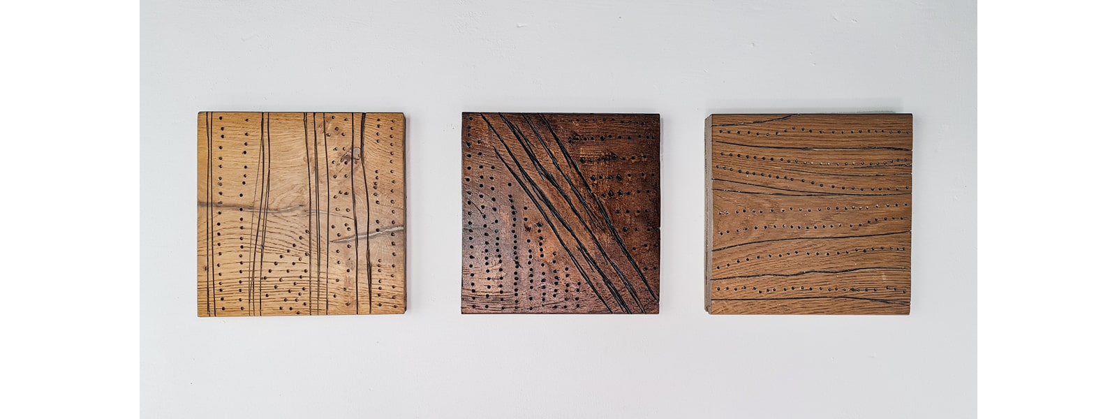 three wood carvings hung up