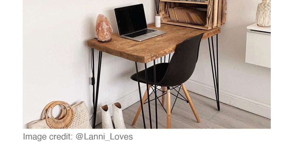 white walled home office with natural wood desk