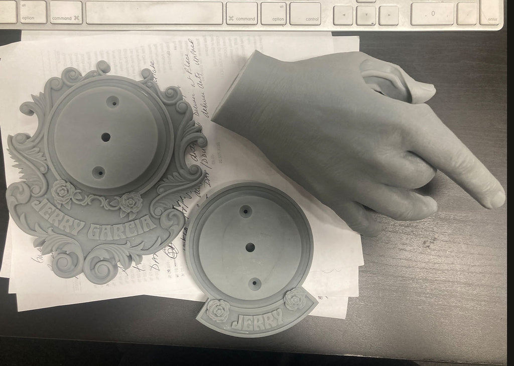 Garcia hand and two plates of SLA 3d printed parts.jpg