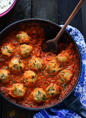 chickpea dumplings in curry tomato sauce