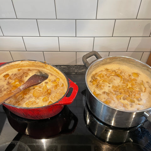 Two pots full of feijoa fruits, simmering away on a stove