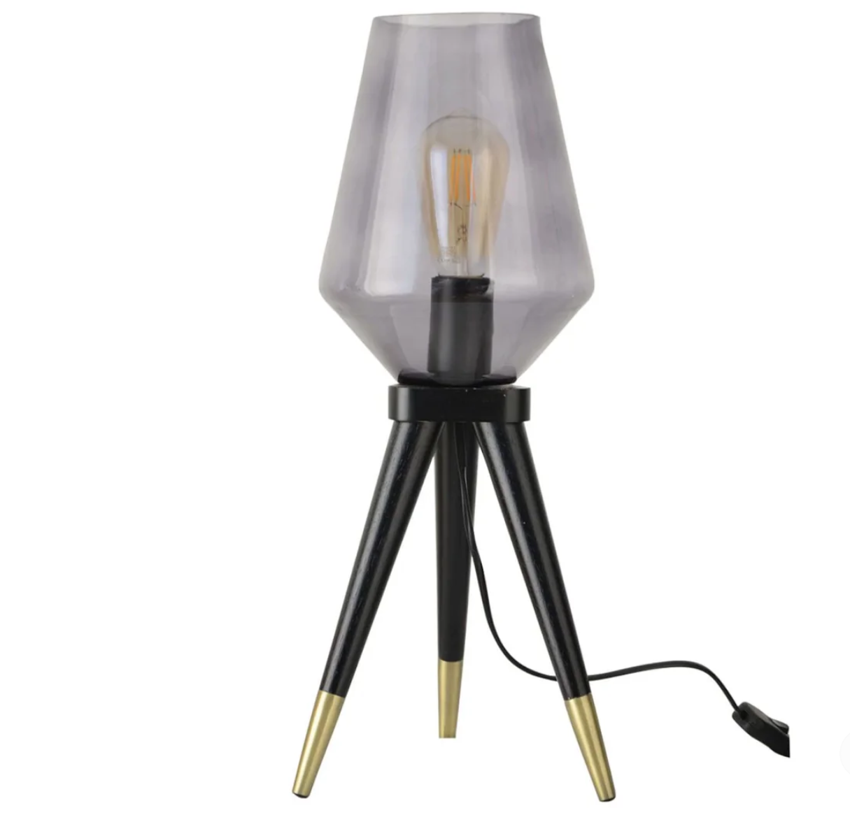 photo d'une lampe transparente avec une ampoule dorée, des pieds noirs et dorés