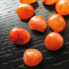 Tumbled citrine on a black table