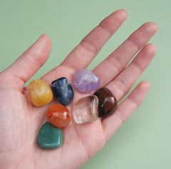 Seven chakra stones held in the palm