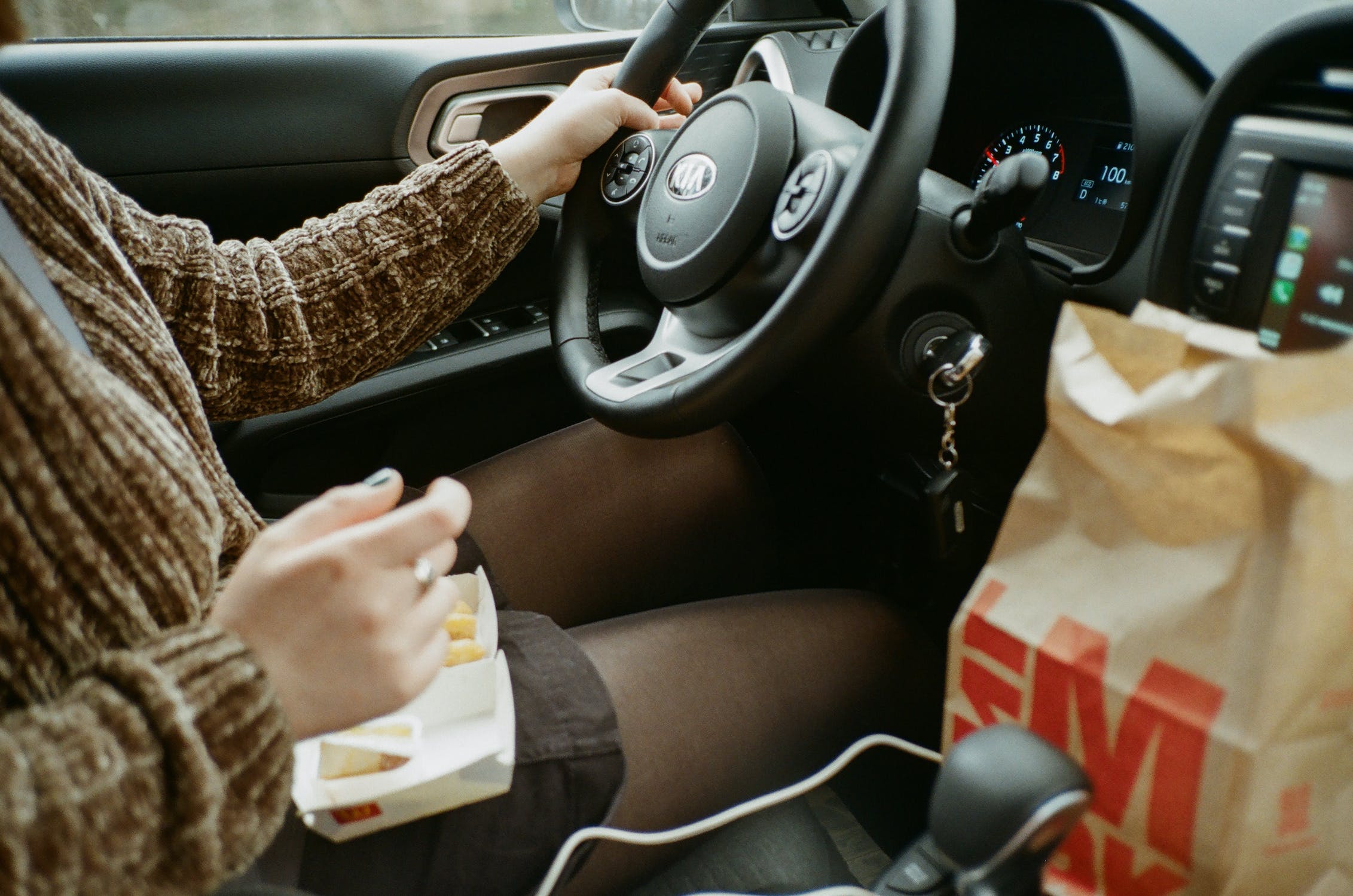 lady driving with food on her lap