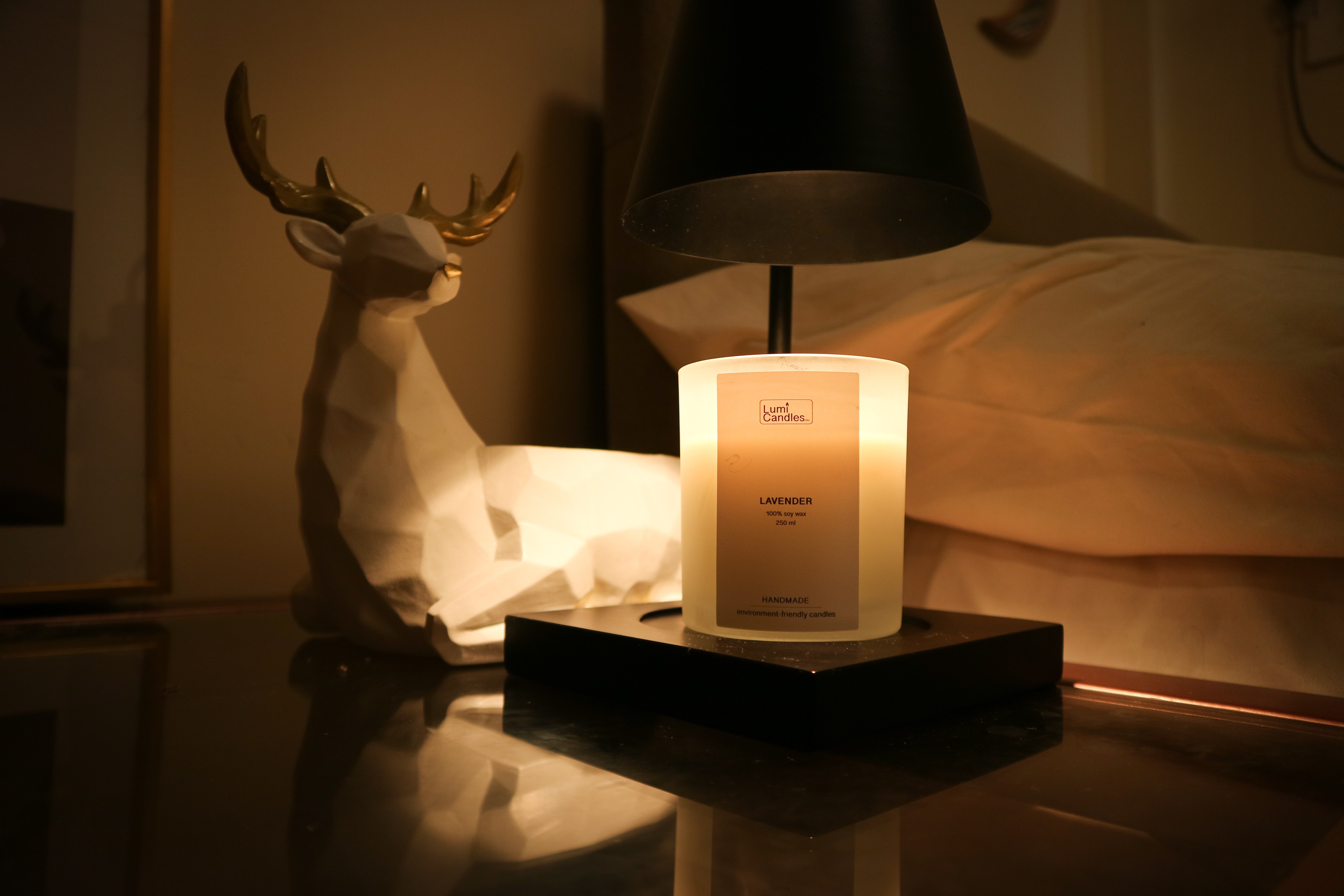 LUMI Lavender scented soy candle lit up in a room