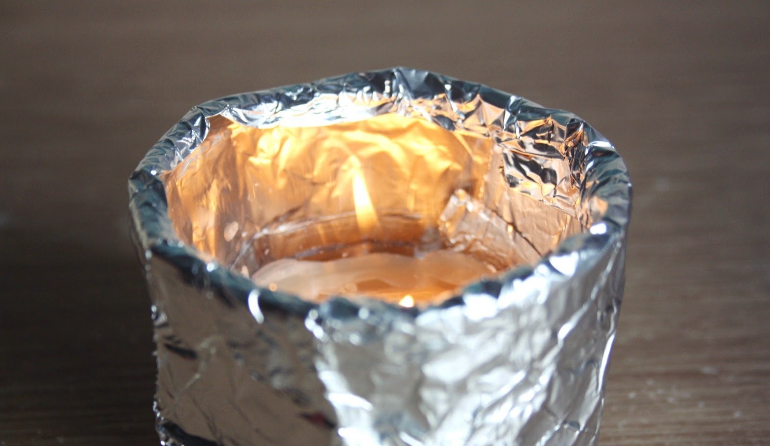 aluminum foil wrapped around a candle's vessel