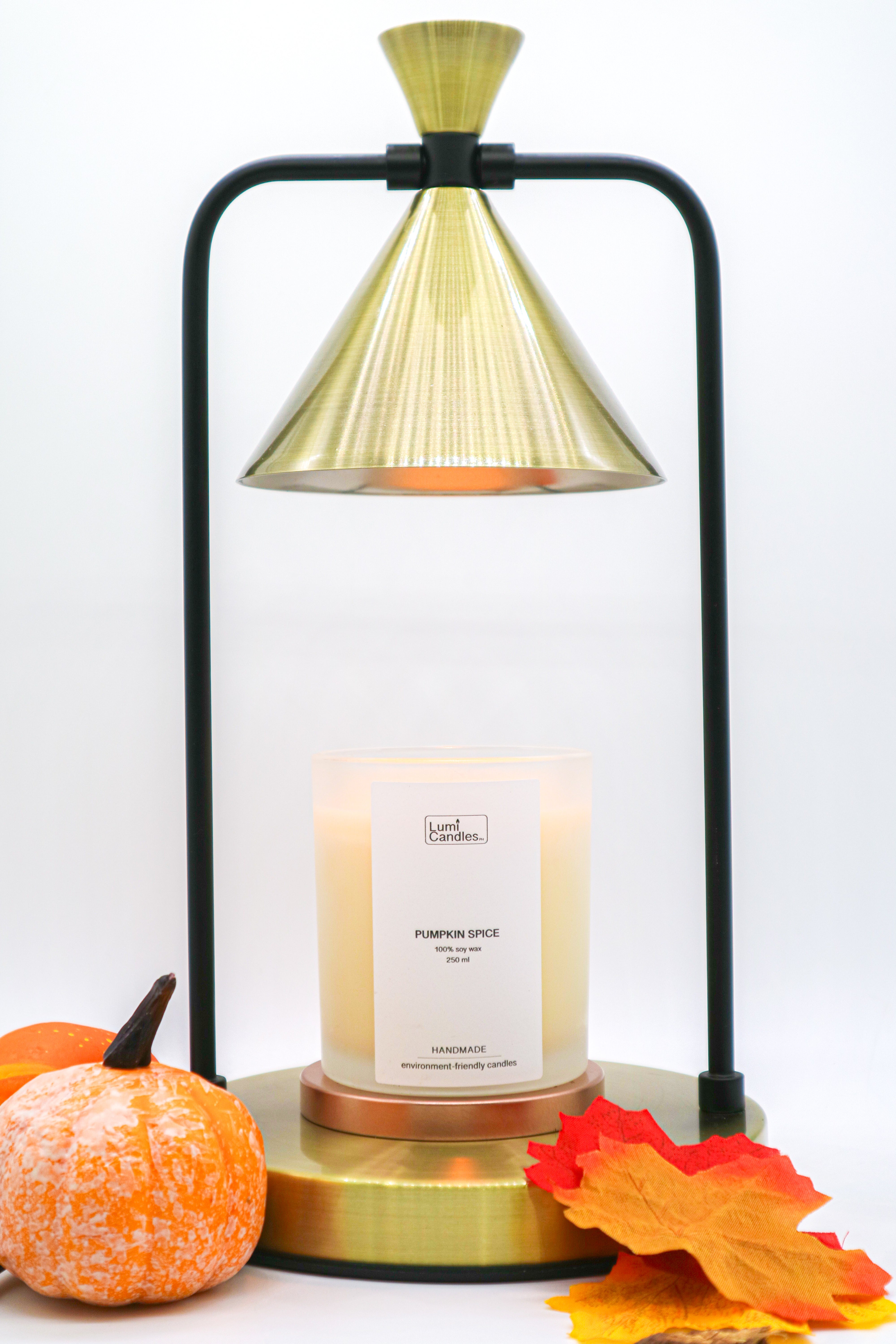 A Pumpkin Spice Lumi Candle with a Candle Warmer