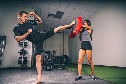 Man and woman sparring kickboxing