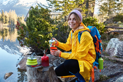 glad-female-tourist-pours-hot-aromatic-drink-from-coffee-maker-has-camping-adventure.jpg__PID:ff9cd59a-a68e-400c-877f-24cb5354628d