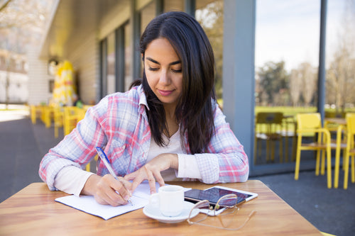 serious-woman-making-notes-outdoor-cafe.jpg__PID:7b694f53-239a-421a-9b5b-1278e0f3db75