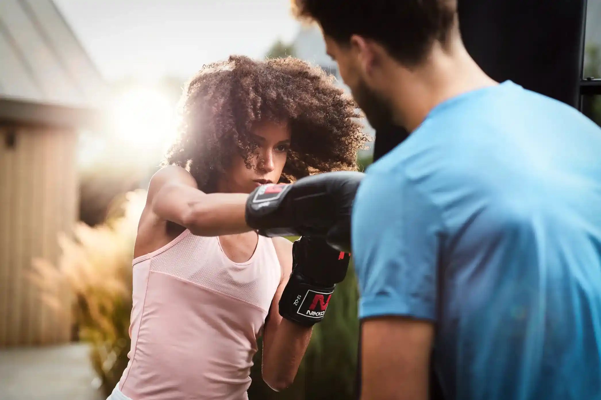 Adults boxing outside with Adult berg playbase