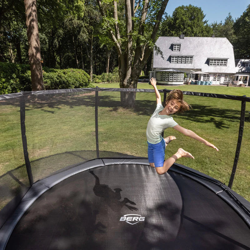 safe in-ground trampoline round in back garden