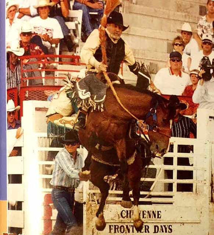 Harry Hancock, riding a bronc in a rodeo.