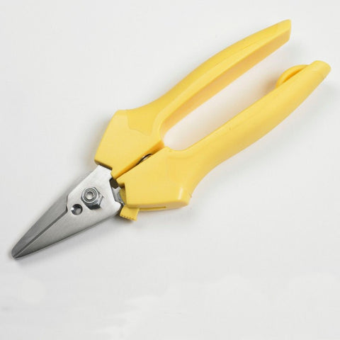 A pair of flower snips with yellow handles.