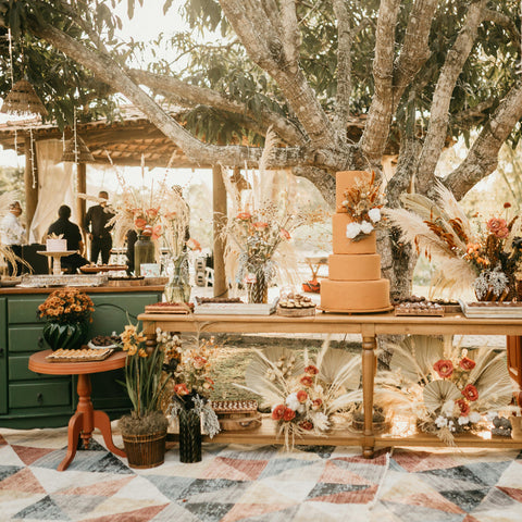A highly decorated wedding feast table, with large cake and lots of dried florals and pampas grass surrounding everything.