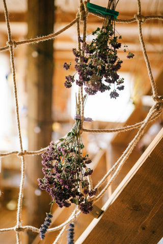 A couple of small floral posies hanging upside down on strings to dry out.