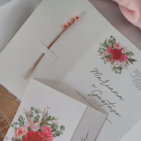 A wedding invitation decorated with dried flowers.