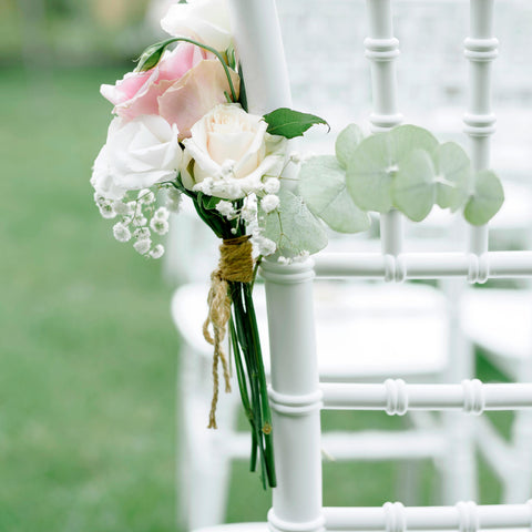 A delicate posy on a wedding guest's chair.