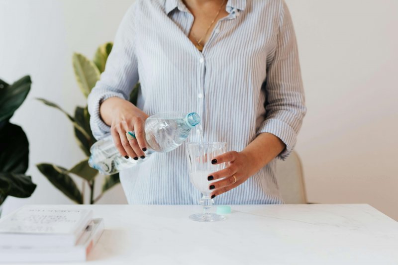 woman pouring a glass of water