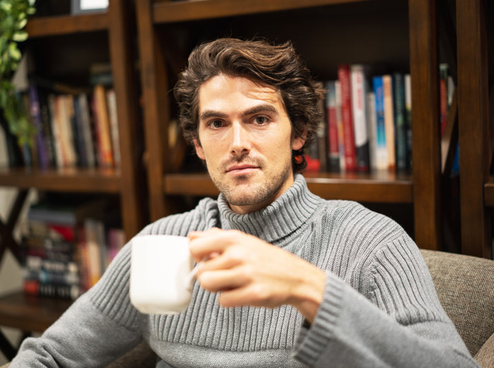 white man drinking tea in white cup