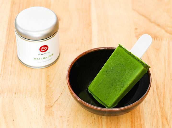 Matcha Green Tea Popsicles in a bowl with matcha tea tin