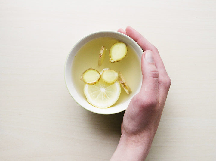 ginger tea infused with lemon in a wide white cup for sore throat relief