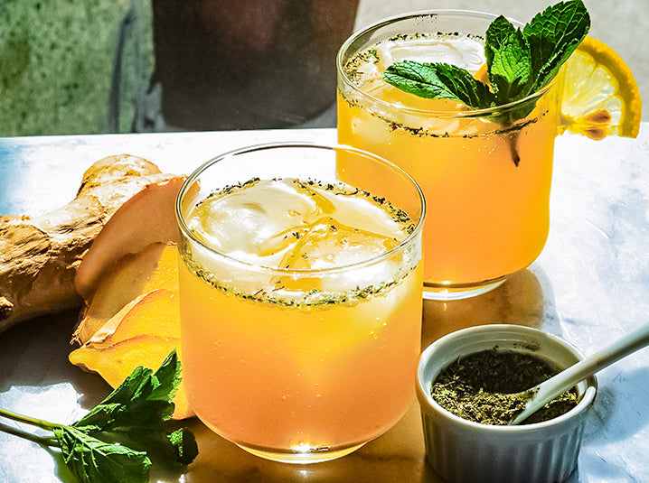 Green Tea Whiskey Cocktail with Ginseng in two glasses