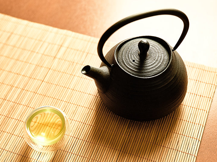 top view of brewed tea in a cup and teapot