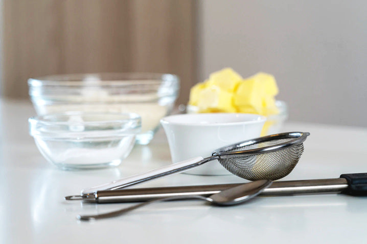 stainless steel Tea Infusers and Strainers with cups in the back