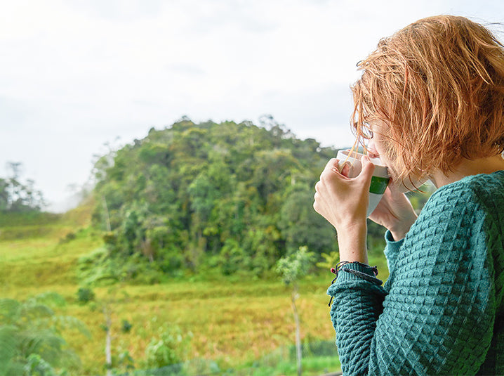 girl drinking tea outside