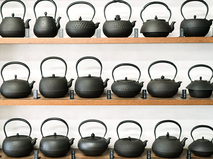 multiple teapots on a shelve